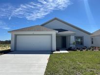 Charming single-story home with a two-car garage and well-manicured lawn at 277 Harper Estates Cir, Lake Wales, FL 33859