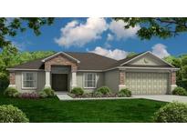 Charming one-story home featuring stone accents, a well-manicured lawn, and an attached two-car garage at 3325 Berkley Dr, Bartow, FL 33830
