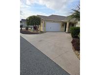 Single-story home with attached garage and landscaped front yard at 3362 Sebastion Ave, The Villages, FL 32163