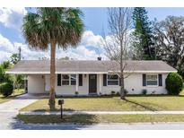 Charming single-story home featuring a palm tree, well-maintained lawn, and inviting curb appeal in a quiet neighborhood at 708 Wynn Dr, Sanford, FL 32773