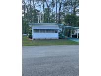 Charming single-story home featuring a carport and freshly landscaped yard at 103 Bougainvillea Dr, Leesburg, FL 34748