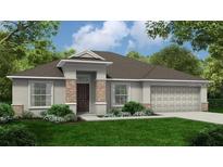 Charming single-story home with stone accents, well-manicured lawn, and an attached two-car garage at 121 W 6Th St, Frostproof, FL 33843