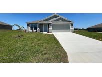 Charming single-Gathering home with a well-manicured lawn and a spacious two-car garage and stone trim at 1212 Caloosa Ridge Ave, Babson Park, FL 33827