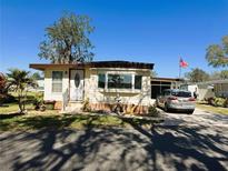 Charming single-story home featuring manicured landscaping, a decorative water fountain, and a welcoming front entrance at 207 Jacaranda Dr, Leesburg, FL 34748