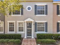 Charming townhome with a welcoming front door and neatly manicured landscaping at 3654 Peppervine Dr, Orlando, FL 32828