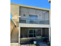 Condo featuring screened in patios with stairs leading to second floor unit at 1640 Juno Trl # 205B, Astor, FL 32102