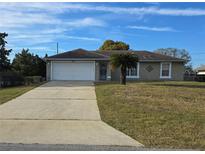 Charming single-story home with a well-maintained lawn and attached two-car garage at 832 Shenandoah Ave, Deltona, FL 32725