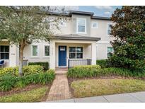Charming townhome featuring a well-maintained front yard and covered entry at 9790 Amber Chestnut Way, Winter Garden, FL 34787