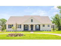 Charming home featuring a quaint covered entryway, fresh green lawn and beautiful exterior accents at 2561 Rogers Rd, Lakeland, FL 33812