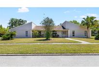 Charming one-story home with well-manicured lawn and mature landscaping at 34 Misty Meadow Ln, Mulberry, FL 33860