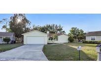 Well-maintained home with a driveway and landscaped front yard at 6310 Doe W Cir, Lakeland, FL 33809