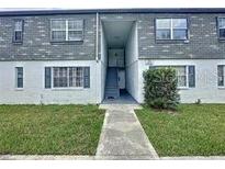 Inviting two-story condo with well-maintained landscaping and a gray shingle roof at 1000 S Semoran Blvd # 404, Winter Park, FL 32792
