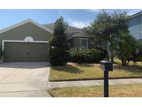 Charming single-story home features a well-manicured lawn and mature landscaping at 1810 Centennial Ave, St Cloud, FL 34769