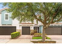 Charming townhouse featuring a brick driveway, attached garage, and well-maintained landscaping at 1880 Garden Sage Dr, Oviedo, FL 32765