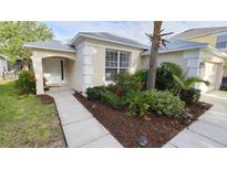 Charming single-story home featuring a manicured lawn and a welcoming front entrance at 8457 Secret Key Cove, Kissimmee, FL 34747
