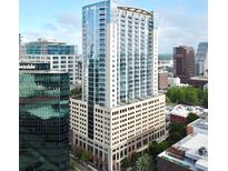 A striking high-rise building with sleek architecture and glass windows stands tall in the city skyline at 155 S Court Ave # 1801, Orlando, FL 32801