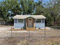Charming cottage-style home featuring a freshly painted exterior with a cozy front porch at 2217 Azalea Ct, Lakeland, FL 33815