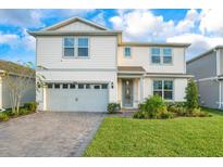 Charming two-story home with a well-manicured lawn and a two car garage at 6066 Arbor Watch Loop, Orlando, FL 32829