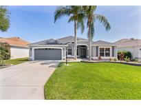 Well-maintained single-Gathering home with two palm trees and a lush green lawn at 7214 Se 171St Brookhaven Pl, The Villages, FL 32162
