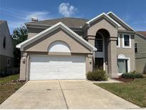 Charming two-story stucco home with a two-car garage and well-maintained landscaping at 904 W Charing Cross Cir, Lake Mary, FL 32746