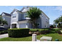 Two-story home featuring well-maintained landscaping, an attached garage, and neutral paint at 1034 Enclair St, Orlando, FL 32828