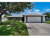 Charming single-story home with a well-maintained lawn, mature tree, and inviting curb appeal at 130 Evergreen Dr, Auburndale, FL 33823