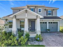 Charming two-story home boasts a manicured lawn and a two-car garage at 2044 Keystone Pass Blvd, Minneola, FL 34715