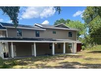 Two-story home featuring neutral siding, a covered front porch, and classic architectural design at 2921 Crutchfield W Rd, Lakeland, FL 33805
