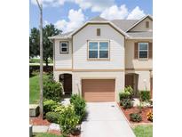 Charming two-story townhome featuring a well-maintained lawn and attached one car garage at 3850 Hampstead Ln, Lakeland, FL 33810