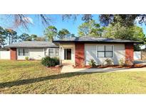 Charming single-story home with a well-manicured lawn and inviting front entrance at 5703 Sw 108Th St, Ocala, FL 34476