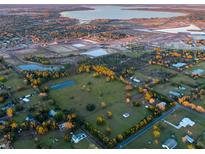 Aerial view of 14.52 acres with a pond and nearby lake at 4775 Hunting Lodge Dr, Saint Cloud, FL 34772