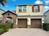 Two-story house with two-car garage and landscaping at 2755 Monticello Way, Kissimmee, FL 34741