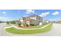 A charming two-story home with lush landscaping in a suburban neighborhood at 2585 Needlepoint St, Kissimmee, FL 34741