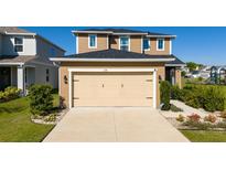 Two-story home featuring a two-car garage and well-maintained landscaping at 1134 Forest Gate Cir, Haines City, FL 33844