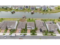 Aerial view of houses and a canal in a residential neighborhood at 3241 Wauseon Dr, Saint Cloud, FL 34772