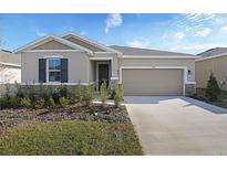 Attractive one-story house with a two-car garage and landscaped front yard at 1706 Sugarbelle Cir, Mascotte, FL 34753