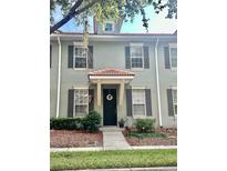 Gray townhome with red tile roof, shutters, and welcoming entrance at 3152 Via Otero Dr, Kissimmee, FL 34744