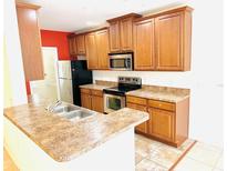 Modern kitchen with stainless steel appliances and ample cabinetry at 3152 Via Otero Dr, Kissimmee, FL 34744