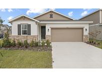 Two-story house with stone accents and a two-car garage at 3345 Chicory Ct, Lake Hamilton, FL 33851