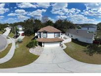 Inviting two-story home featuring a two-car garage, neutral tones, and manicured lawn at 13330 Briar Forest Ct, Orlando, FL 32828