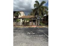 Charming condo featuring lush palm trees and a partially fenced yard with dedicated guest parking at 2647 Surrey Ct # 2647, Kissimmee, FL 34741