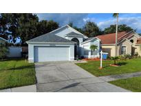 Charming single-Gathering home with well-maintained lawn and two car garage at 5906 Rywood Dr, Orlando, FL 32810