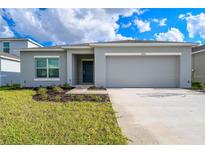 One-story home with attached garage and landscaped lawn at 4762 Vellacito Way, Davenport, FL 33897