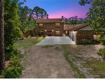 Beautiful two-story brick home with well-maintained landscaping and a long driveway at 1775 Sundance Dr, St Cloud, FL 34771