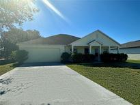 Charming single-story home featuring a well-maintained lawn and a two-car garage at 1928 Drum Dr, Kissimmee, FL 34759