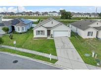 One-story house with a garage and solar panels, well-maintained lawn at 816 William Way, Haines City, FL 33844