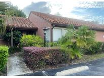 Charming home featuring a red tile roof and nicely landscaped front yard at 618 Saint Johns Ct, Winter Park, FL 32792