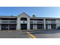 Two-story building exterior featuring a stucco facade, balconies with white railings, and parking in front at 5245 W Irlo Bronson Memorial Hwy # 160, Kissimmee, FL 34746