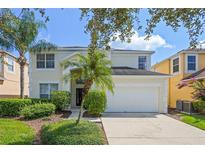 Charming two-story home with a well-maintained lawn, beautiful landscaping and two car garage at 121 Madiera Beach Blvd, Kissimmee, FL 34746