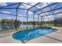 Screened pool overlooks scenic lake views on a sunny day at 121 Madiera Beach Blvd, Kissimmee, FL 34746